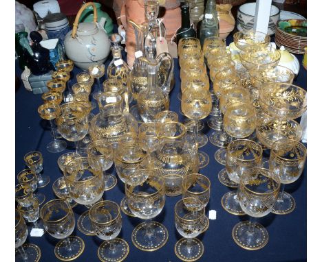 A good and  extensive collection of cut and gilt table glass, early 20th century, including decanters, champagne saucers and 