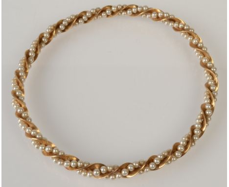 A 9ct. gold spiral bangle with two strands of small pearls.   Condition report:  Small flaws in some pearls, no issues noted.