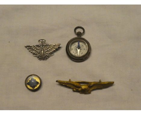 A Second War RAF escape compass from a button, small pocket fob compass, RAF badge and a silver winged wheel badge