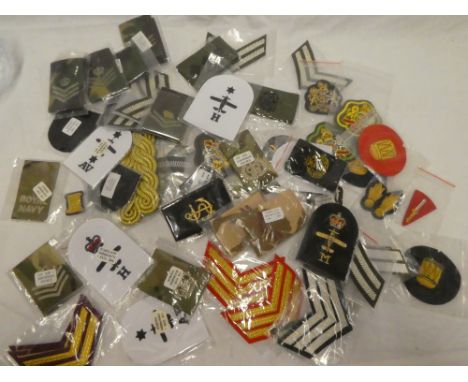 A selection of various Army cloth insignia including chevrons, arm badges, etc