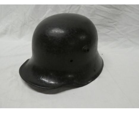 A First War German M16 steel helmet with original black painted finish minus liner