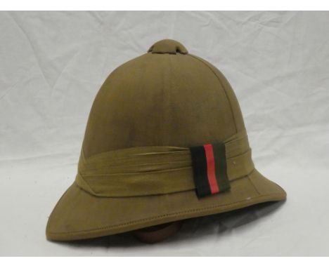 An early to mid 20th Century khaki pith helmet with liner and chin strap