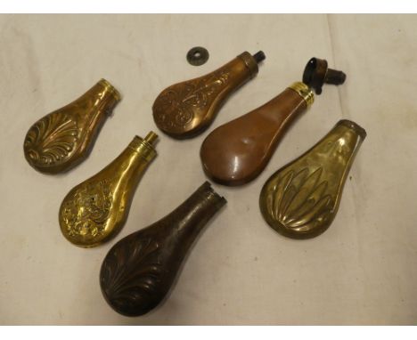 A selection of various brass and copper powder flask bodies and parts