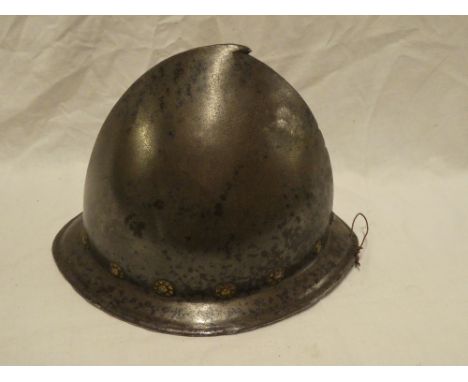 A 16th Century steel cabasset helmet with pear-stalk top and brass roundels, 7" high