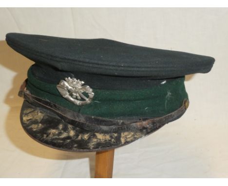 A First War green cloth military Recruiting Officer's peaked cap of the Duke of Cornwall's Light Infantry with silver plated 