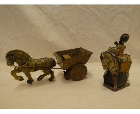 A 1960's clockwork tin-plate Guardsman drummer on horseback and a tin-plate Marx horse and cart (2)