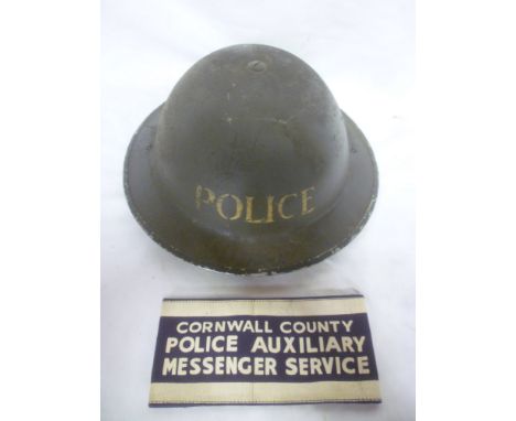 A Second War Home Service pattern police helmet together with "Cornwall County Police Auxiliary Messenger Service" arm band (
