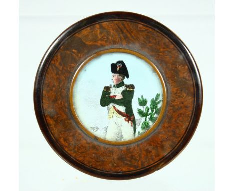 A VICTORIAN WOODEN CIRCULAR SNUFF BOX, the lid with Napoleon. 2.75ins diameter.