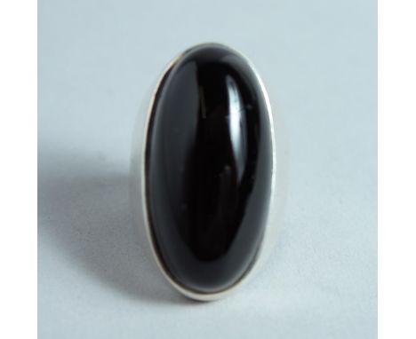 A BLACK ONYX AND SILVER RING