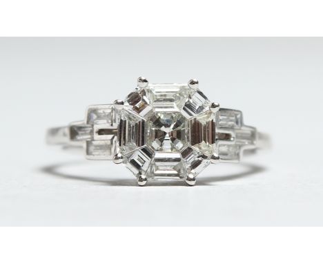 AN 18CT WHITE GOLD DIAMOND SET RING. The central diamond cluster of 1.17cts, the baguette diamonds to the shoulders of 0.28ct