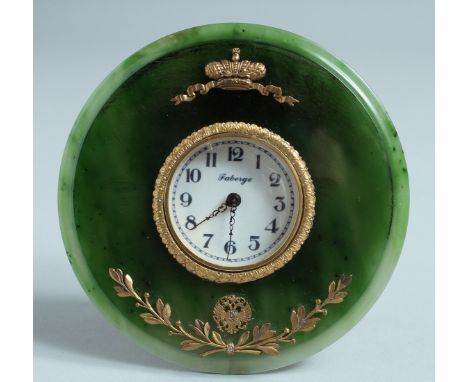 A SUPERB RUSSIAN SILVER GILT AND JADE CIRCULAR CLOCK on an easel support. 11cm diameter. Mark: R A., Faberge mark, 84 &amp; h