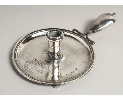 A RARE QUEEN ANNE SILVER CHAMBER CANDLESTICK, crest with three lions, handle engraved I. M. 5.5ins diameter. London 1711. Mak