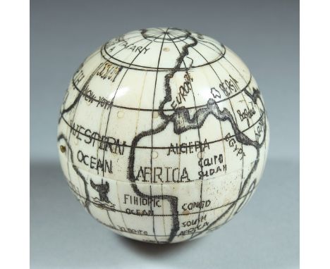 AN ETCHED BONE BALL SHAPED COMPASS. 2.5ins diameter.