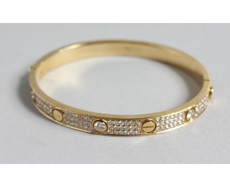 A SUPERB 18CT GOLD AND DIAMOND SCREW BANGLE set with six single stone diamonds and twelve rows of eighteen small diamonds.