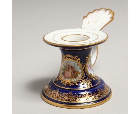 A SMALL 19TH CENTURY MEISSEN CANDLESTICK, blue ground edged in gilt with painted panels. Meissen cross swords mark. 2ins diam