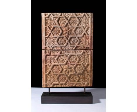 Ca. AD 1100 - 1200.A pair of rectangular terracotta decorative tiles. The upper surface has an intricately designed central r