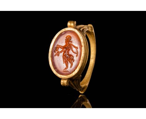 Ca. AD 200 - 300.A late Roman 22 ct gold ring. It has a round hoop decorated with “volute” on the exterior, an oval carnelian