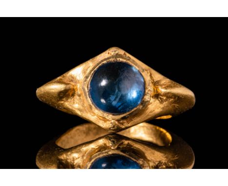 Ca. AD 200 - 400.A late Roman 22 ct gold ring with an oval band. It has a polygonal bezel securing a circular blue sapphire c