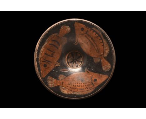 Ca. 400 - 300 BC.A shallow ancient plate, decorated with three sea breams swimming around the central recess for garum (fish 