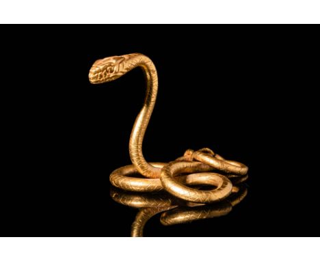 Late Period, Ca. 664 - 332 BC.An Egyptian 20.5 ct gold figure of a snake, depicted in an attacking position. The head protrud