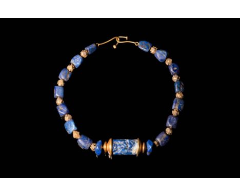 Ca. 2334 - 2154 BC.A fine Mesopotamian necklace composed from polygonal lapis lazuli and gold decorated with filigree beads. 