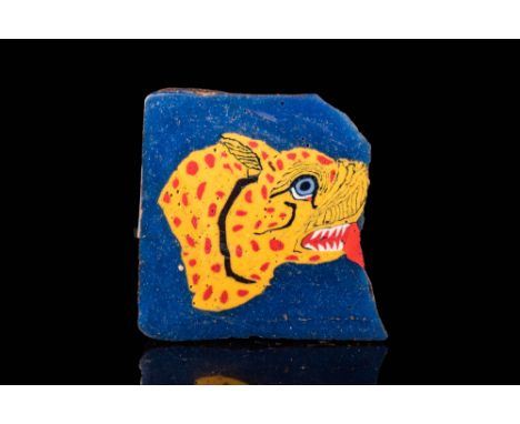 Ca. 100 BC - AD 100.A fantastic fragment of Roman mosaic glass depicting a coloured tiger in a deep-blue frame. The animal is