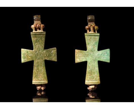 Ca. AD 900 - 1200.A Byzantine bronze enclopion composed of two halves. The frontal side is decorated with engraved crucifix a