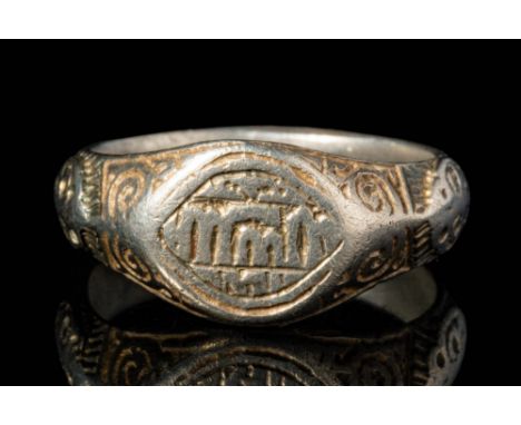 Ca. AD 1300 - 1500.A Medieval silver ring with an internally wide flat band. The exterior is convex and decorated with geomet