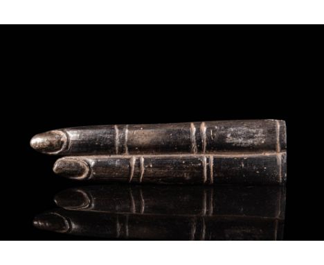 Late Period, Ca. 664 - 332 BC.An Egyptian black stone double finger amulet depicting an outstretched index and middle finger.