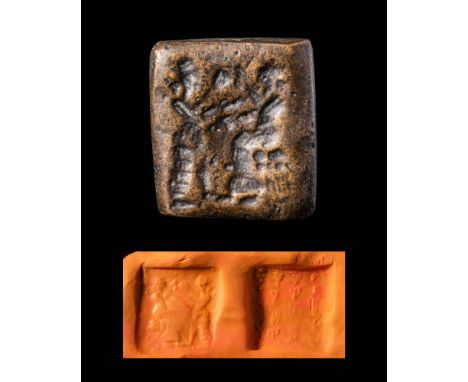 Ca. 2500 - 2000 BC.A Sumerian hard stone seal depicting two gods. On the right there is a seated god dressed in a long robe a