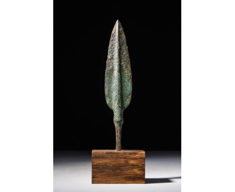 Western Asiatic/Aegan, Ca. 1200 - 700 BC.A bronze spearhead boasts a leaf-shaped blade with a prominent midrib that runs down