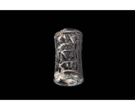 Predynastic to Early Dynastic Period, Ca. 3200 - 2900 BC.An Egyptian hard black stone cylinder seal depicting a divine figure