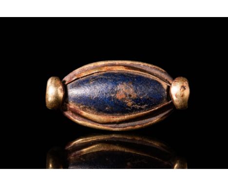 Late to Ptolemaic Period, Ca. 664 - 30 BC.An Egyptian elongated, polished lapis lazuli stone set in a silver openwork frame a