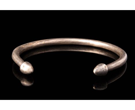 Ca. 700 - 200 BC.A Celtic silver bracelet; circular in section; decorated with symmetrical pointed finials. For similar see: 