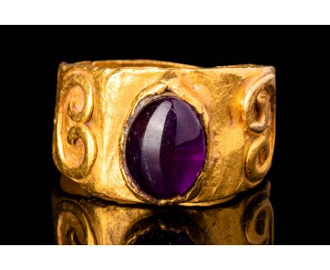 Ca. AD 100 - 200.A Roman 23.4 ct old ring with an amethyst stone set in a raised bezel. The round hoop is decorated on the sh