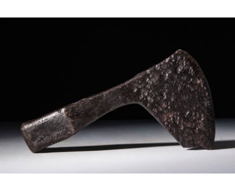 Ca. AD 900 - 1100.An iron battle axe featuring a rounded socket and a long head, flaring towards the blade. Beyond the battle
