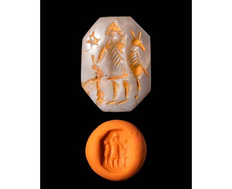 Ca. 600 - 500 BC.An octagonal Neo - Babylonian stamp seal depicting a standing god with a horned tiara facing left, holding a