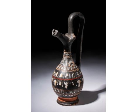 Ca. 330 - 320 BC.An Apulian Gnathia ware Epichysis with a pear shaped body with elaborate decorative bands including, dots, o