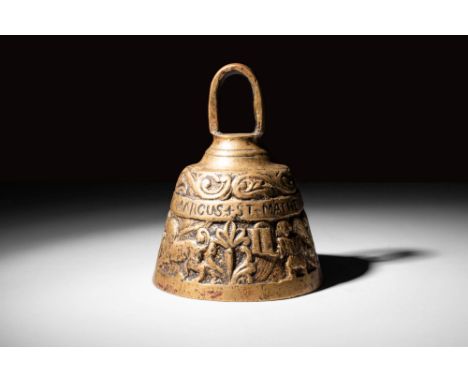 Ca. AD 1400.A late medieval British brass bell decorated with low relief on two registers. The lower and main one is adorned 