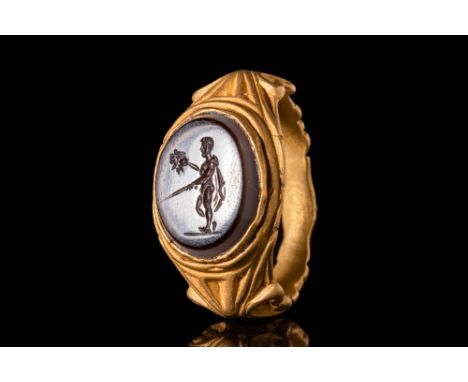 Ca. AD 200 - 400.A Roman 21.5 ct gold ring with an oval banded agate intaglio depicting Perseus holding the head of Medusa. T