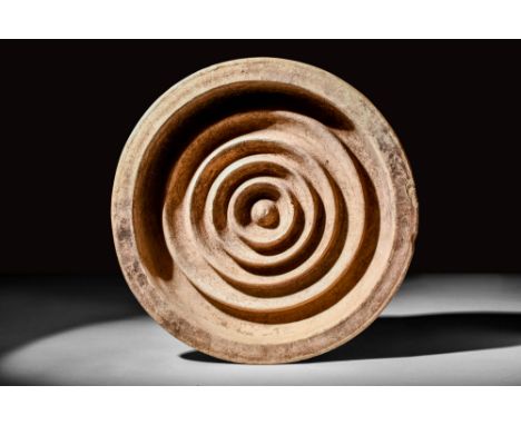 Ca. AD 100 - 300.A Roman pottery bread stamp with flat bottom and conical body connected to a flat rim. Concentric, circles i