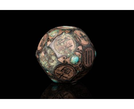 Ca. 206 BC - AD 220.A Chinese Han Dynasty inlaid polygonal game dice. The numbers are written in Chinese characters in a seal