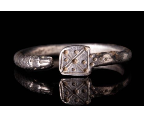 Ca. 200 BC - AD 100.A Romano-Celtic silver round band snake ring. Its bezel is decorated with geometric motifs composed of di
