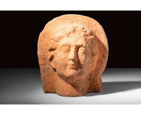 Ca. 400 - 300 BC.An Etruscan terracotta, mould-made votive head with detailed anatomical features. Ex votos were also used by