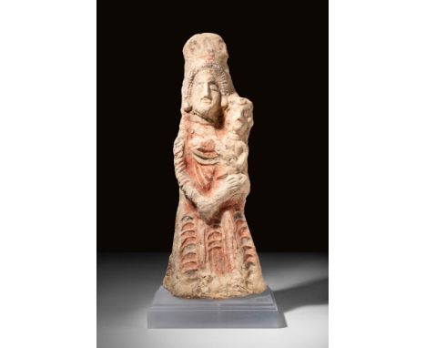 Ca. 700 - 500 BC.A Phoenician terracotta statuette of crowned goddess Astarte. She is dressed in people and kalathos, holding