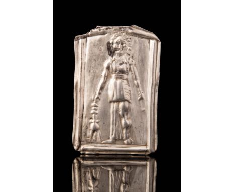 Ca. 600 - 400 BC.A Greek silver plaque depicting a standing Gorgon holding a tripod; the portrait is framed by raised paralle