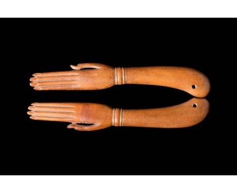 New Kingdom, Ca. 1550 - 1069 BC.An Ancient Egyptian hand-carved clapper with red/brown wood which mimics sun-washed skin. The