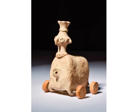 Ca. 3000 - 2000 BC.A gorgeous pull-toy that is hand-built from beige and citrine-hued terracotta that resembles a period-accu