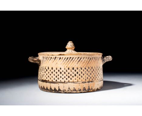 Ca. 700 - 600 BC.A Greek Corinthian black-glaze pyxis with lid. The central register is decorated with dots, the lower with w