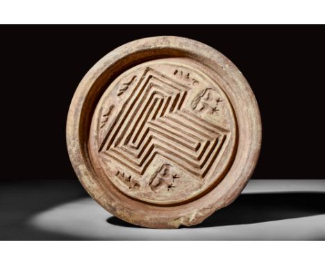 Ca. AD 100 - 300.A Roman pottery bread stamp with flat bottom and conical body connected to a flat rim. A "T" shaped decorati